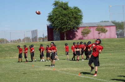 Coyotes' QB's and receivers working on passing routes.