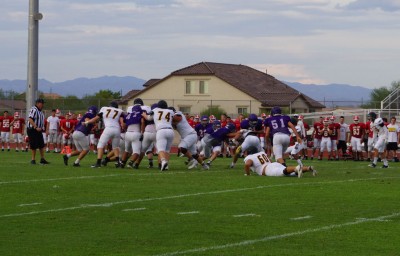 Queen Creek's defemse swarms to make the tackle.