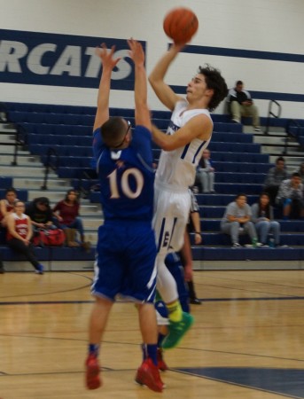 Sabercats' guard Norman Touhey (3) puts up a floater in Wednesday's game.